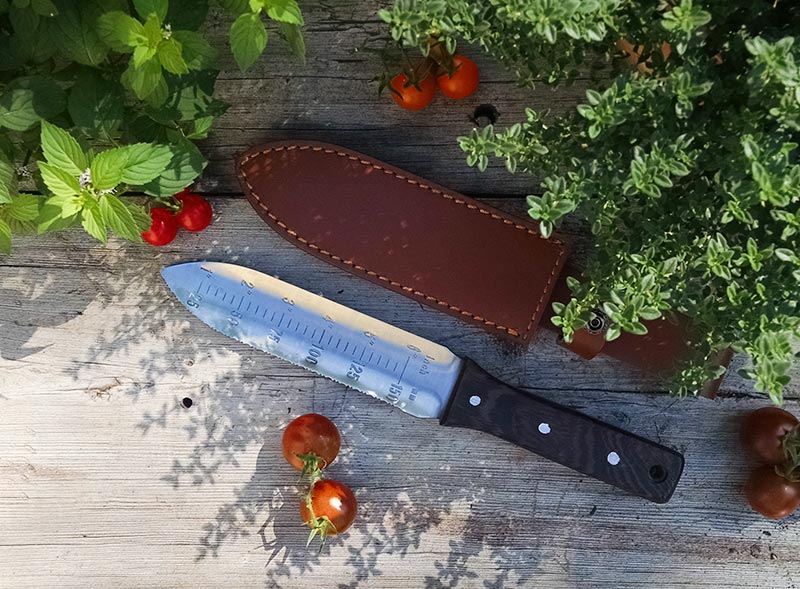 Hori Hori Knife, or soil knife, with leather sheath.