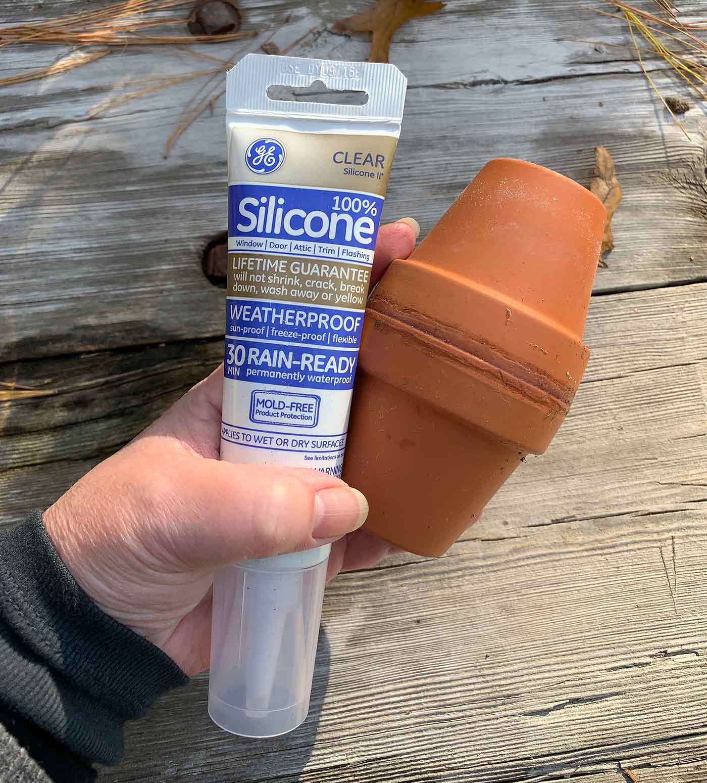 A tube of waterproof silicone used to glue terracotta pots together to make an olla.